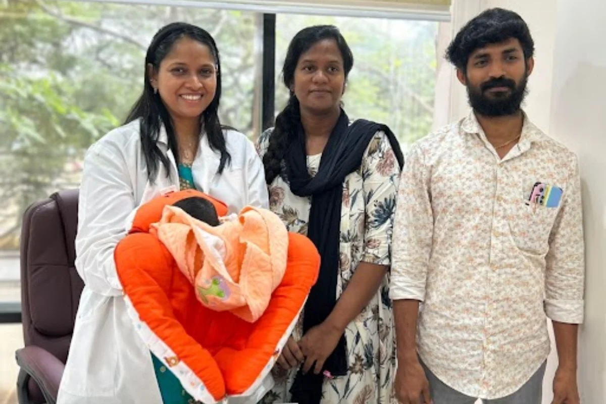 Grateful parents with Dr. Rukkayal and their newborn